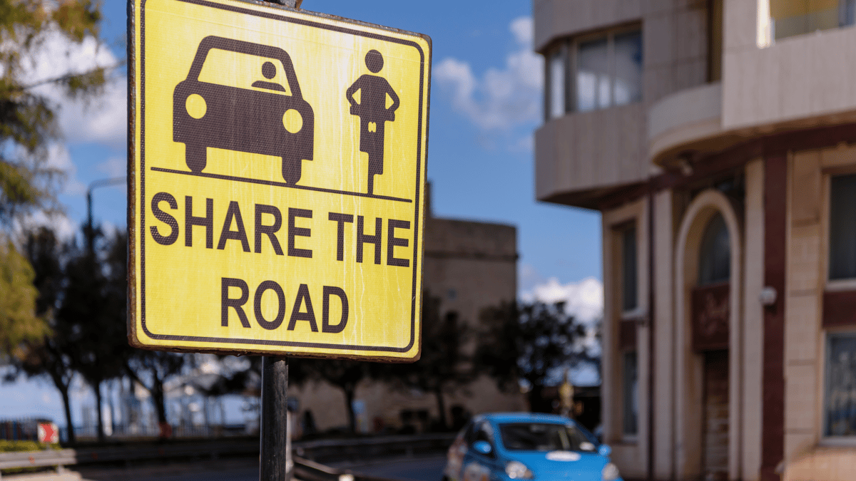 A yellow caution sign with the reminder to share the road