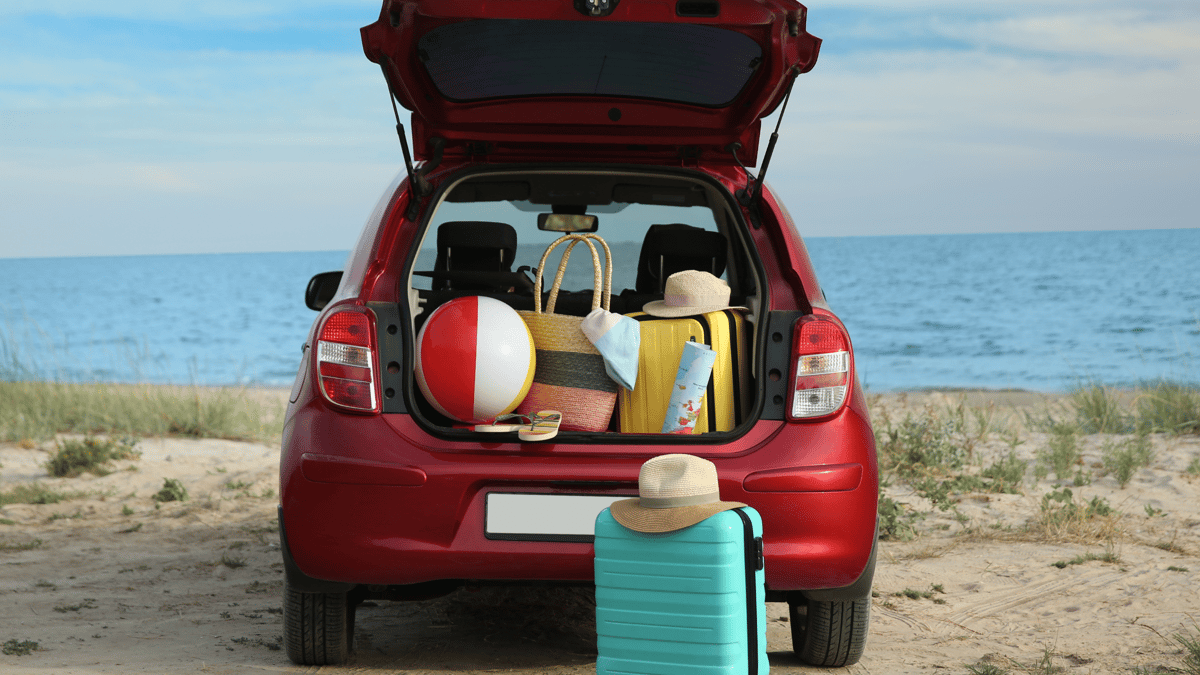 Image of a car with the trunk open and full of beach stuff